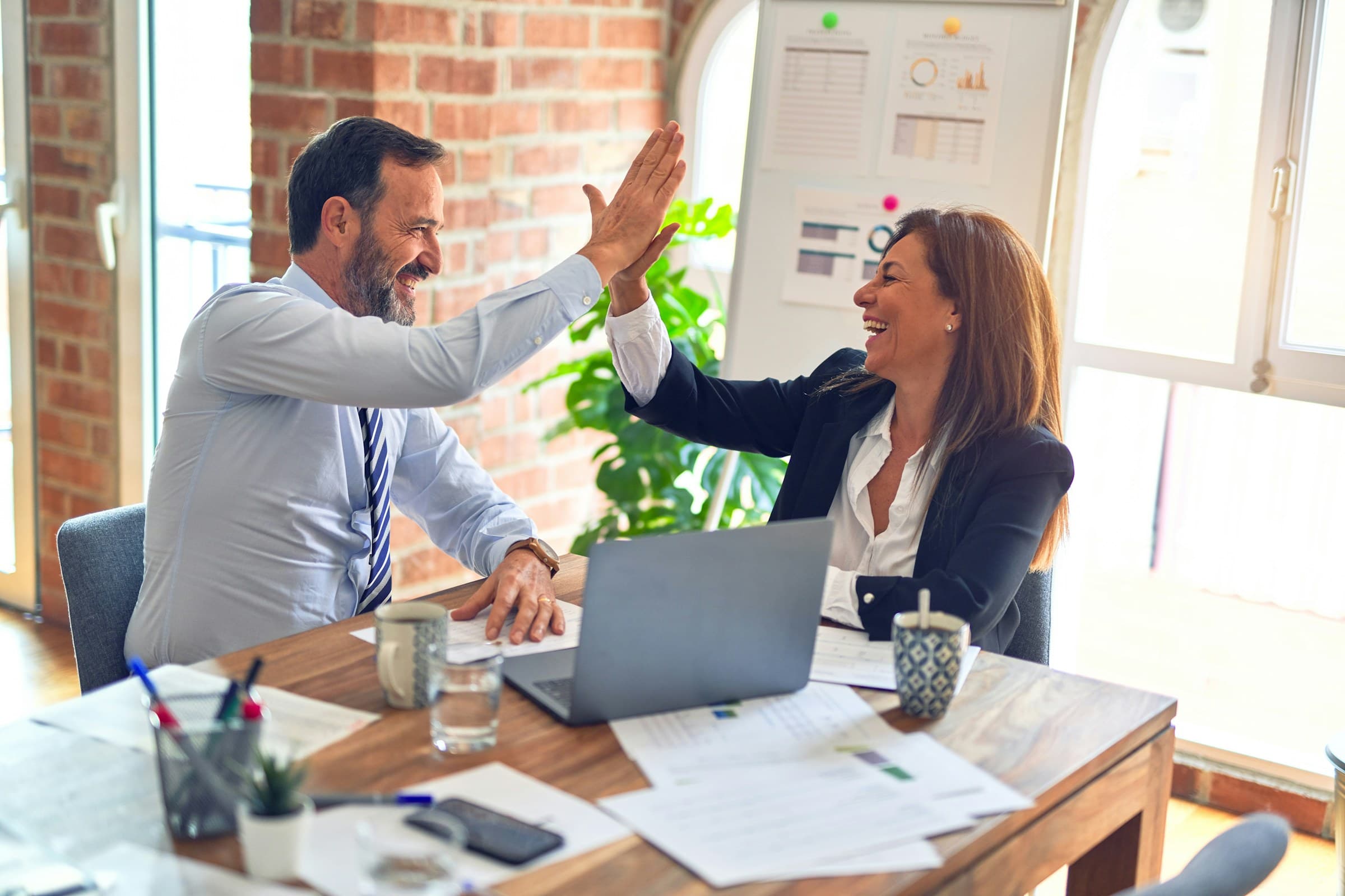 A SMAART Payroll specialist celebrating a successful outcome with a client